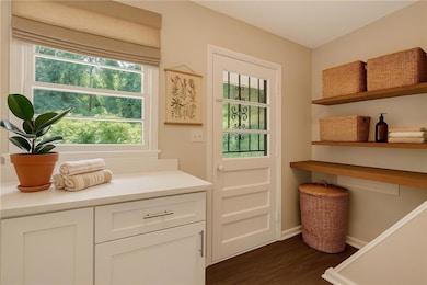 Entryway with wood finished floors and baseboards