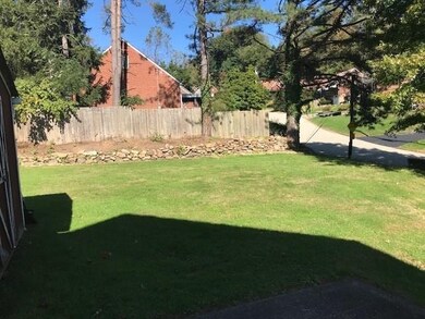 The back yard with the natural spring and rock wal