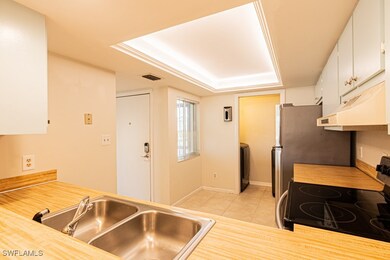 Kitchen with electric range, visible vents, under