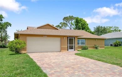 Ranch-style house featuring brick siding, a garage
