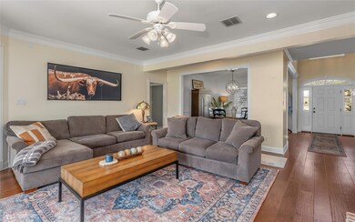 Living area featuring ceiling fan with notable cha