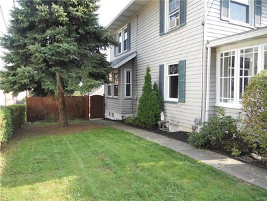 The front and side lawn are surrounded by a hedge 