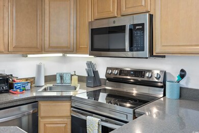 Kitchen with light brown cabinets, stainless steel