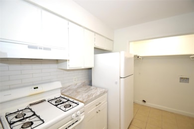 Kitchen featuring white appliances, ventilation h