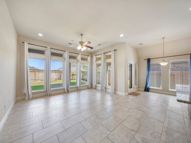 Elongated windows and light tile flooring give a bright and airy feel throughout the home while also providing a soothing indoor-outdoor energy.