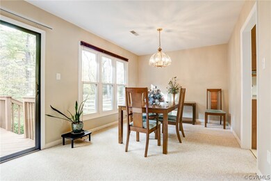 Dining Room with Carpet and Chandelier