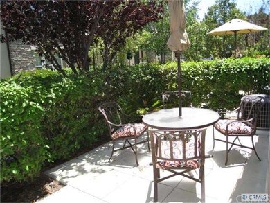 Front Patio surrounded by high shrubs