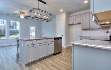 Kitchen with dishwasher, light wood-type flooring, backsplash, a ceiling fan, and recessed lighting