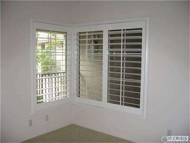 Bedroom has plantation shutters, bathroom with dou
