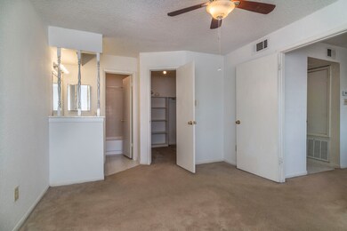 Bedroom 1 facing bathroom and walk-in closet (carp