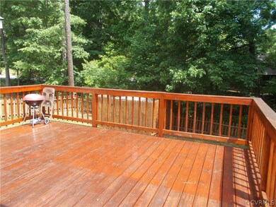Huge deck overlooking private backyard with picket