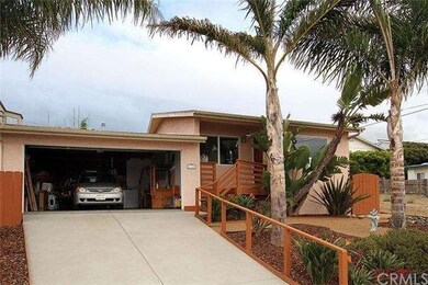 Garage has stairs with handrails to the kitchen.