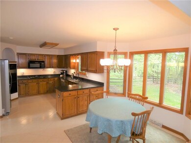 The fully equipped kitchen and breakfast areas offer open concept and direct access to the adjacent family room.  The bay of Andersen windows provide a panoramic view of the spectacular rear lot.