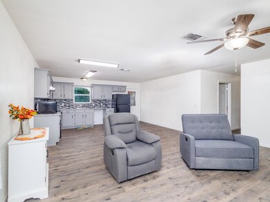 Living room with light wood-type flooring and ceil