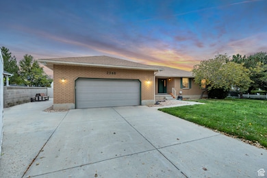 Ranch-style home with brick siding, concrete driveway, an attached garage, and a shingled roof