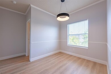 Unfurnished room featuring baseboards, light wood