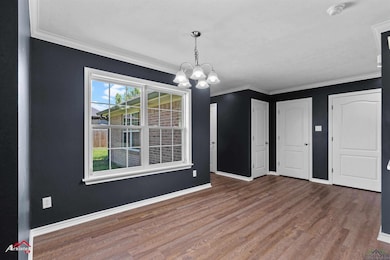 Unfurnished dining area featuring wood finished fl