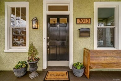 Entry with original transom, new light fixtures, door hardware, locking mailbox and custom house numbers!