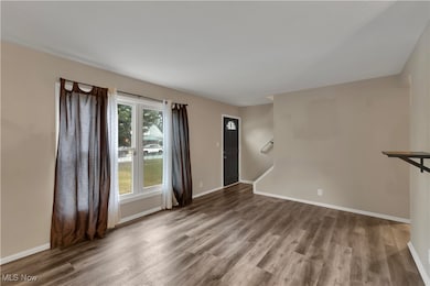 Unfurnished living room with wood finished floors