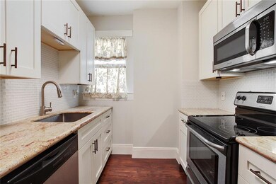 Kitchen has stainless appliances and granite countertops