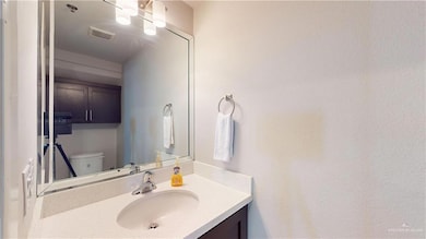 Half bathroom featuring toilet, vanity, and visible vents
