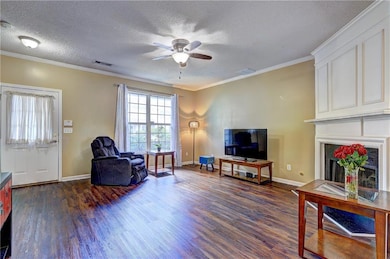 Living area featuring dark wood-style floors, ceil