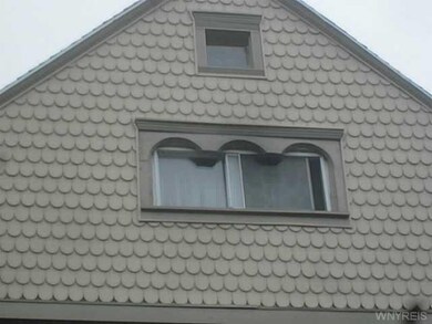 Exterior Front. Scallop detail, front shingles.