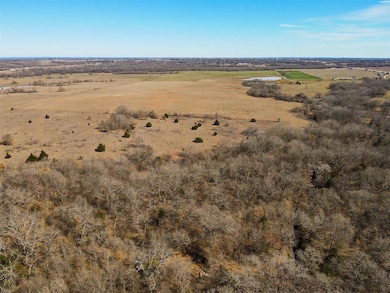 Aerial view of property and surrounding area featuring rural landscape