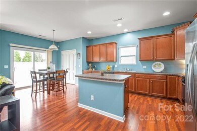 Kitchen + eating area. Doors lead to back patio