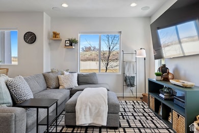 Living room with recessed lighting, baseboards, and wood finished floors
