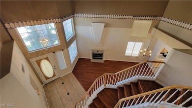 Foyer entrance with a chandelier, a high ceiling,
