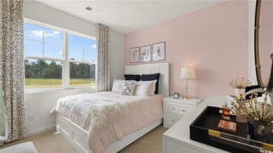 Bedroom featuring light carpet and baseboards