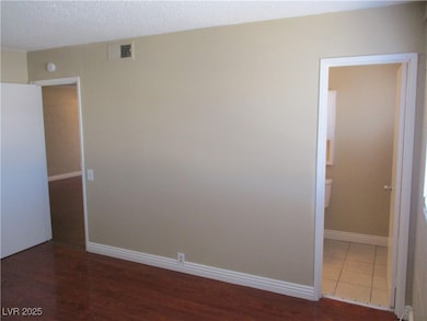 Unfurnished room featuring wood finished floors, b