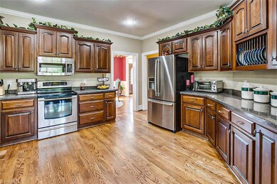 Kitchen, all stainless appliances remain, including refrigerator