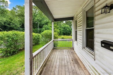 Porch featuring a lawn