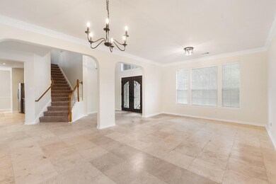 Foyer entrance featuring arched walkways, a chand