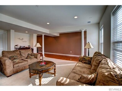 Big foyer with hardwood floors and columns (from r