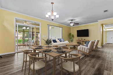 Dining room featuring a chandelier, baseboards, d