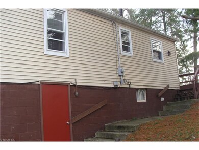 Side of home with door to garage