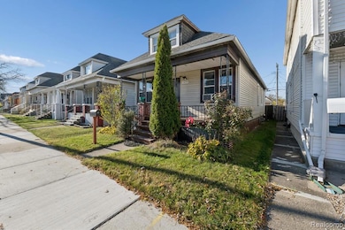 View of front of home featuring a porch, a front yard, a shingled roof, and a residential view