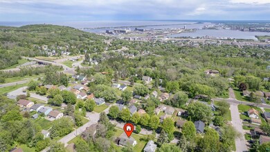Birds eye view of property with a water view