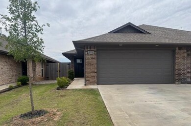 Single story home featuring brick siding, concrete