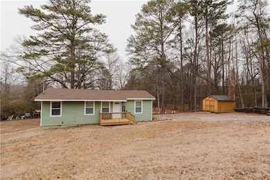 Ranch-style house with a wooden deck, a front yard