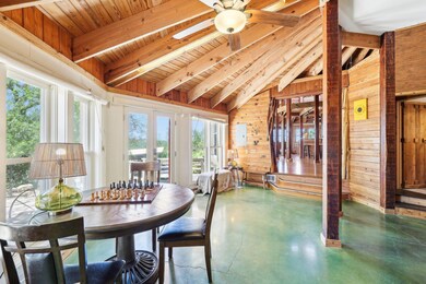 Sunroom / solarium featuring beam ceiling, french
