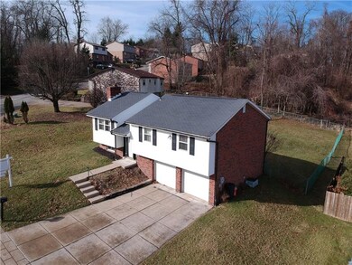 Brick house shown from the side to see the fenced 