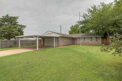 View of front facade with an attached garage, concrete driveway, and brick siding