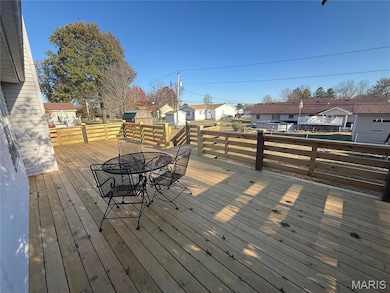 Wooden terrace with outdoor dining space and a residential view