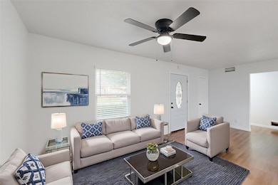 Living room with hardwood / wood-style flooring an