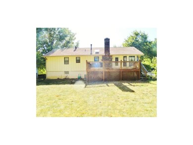 Back of home with deck, hot tub and fenced yard wi