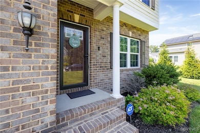 Property entrance featuring brick siding